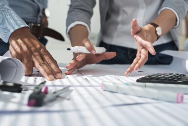 Two employees discussing blueprints