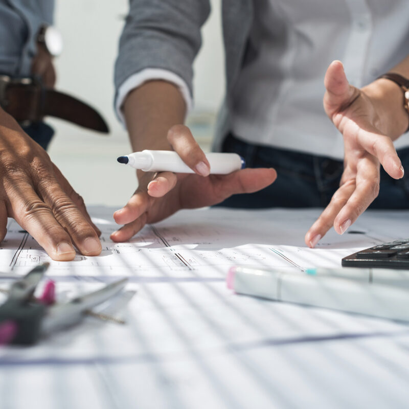 Two employees discussing blueprints